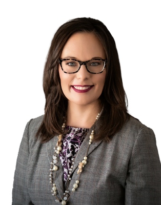 A woman in glasses wearing a suit and necklace, who is a Jefferson City Injury Attorney.